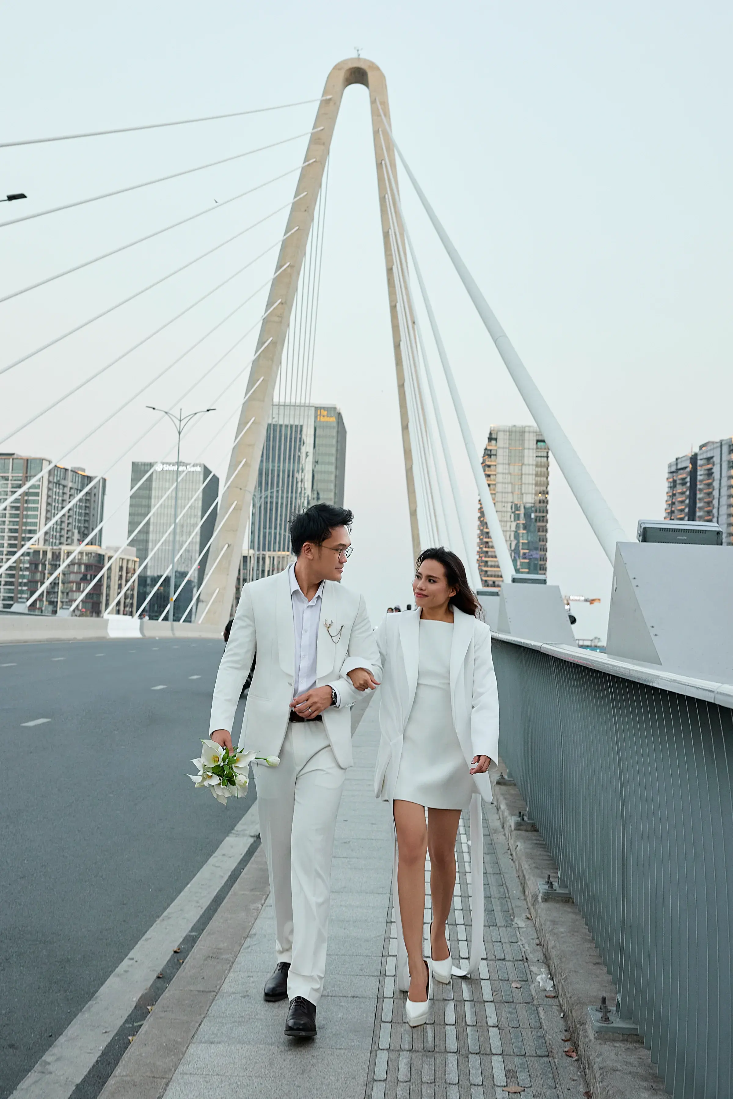 Josh and Analie walking together on a bridge