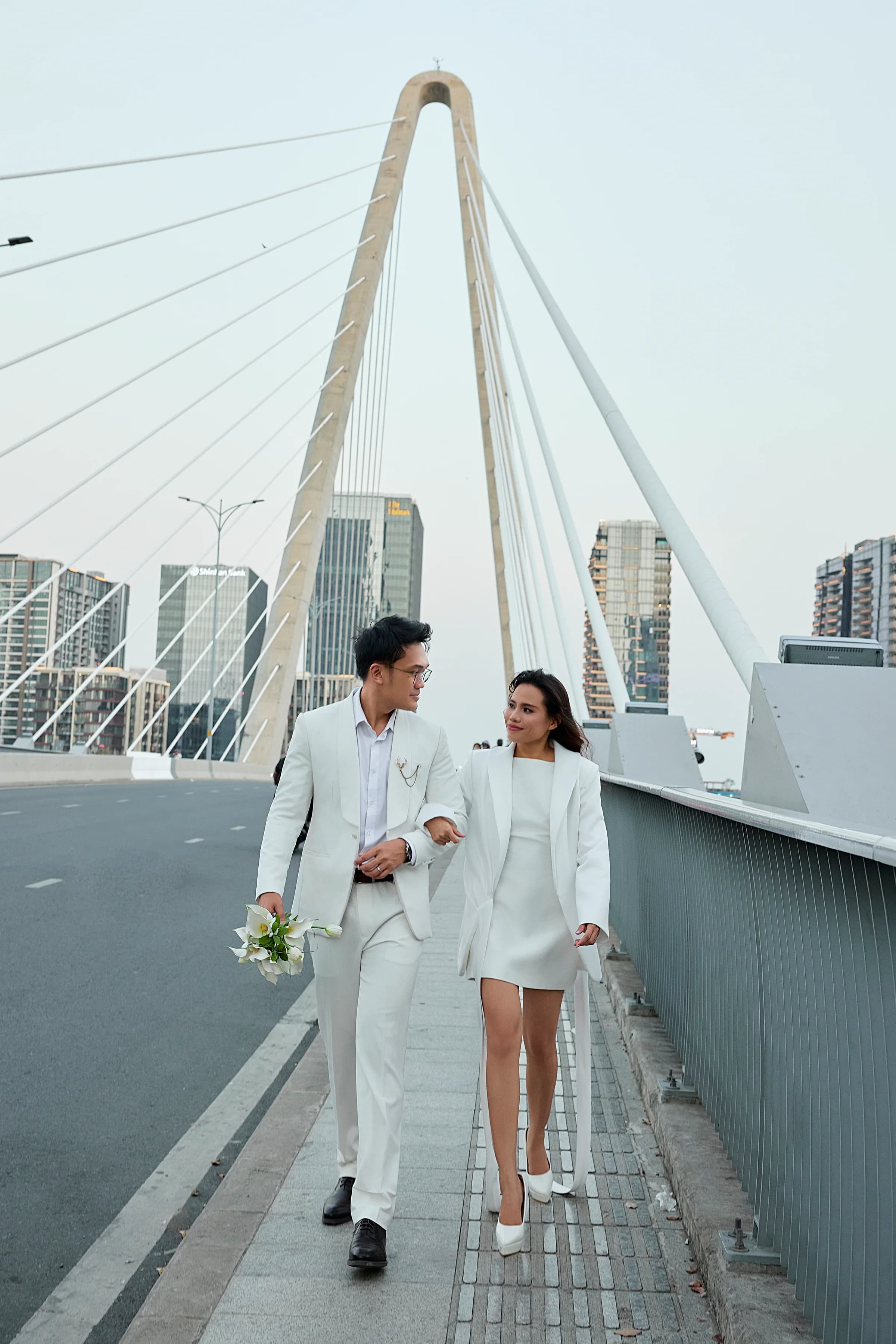 Josh and Analie walking together on a bridge